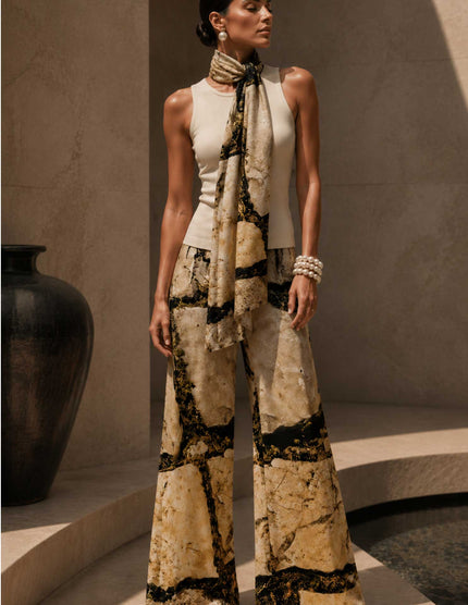 Woman wearing a scarf and palazzo pants with the "Cobble" print