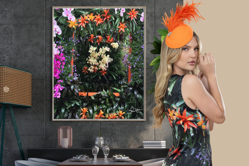 Modern room with "Flowers Galore" art print on the wall behind a woman wearing the print on her dress